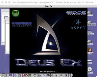 The Deus Ex splash screen with Ion Storm, Eidos, Westlake Interactive and Aspyr logos, reading Loading objects, running in a window on a Mac OS 9 desktop with hard disk icons down the right edge.