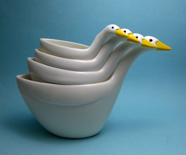 Rubber ducks arranged in a white teacup